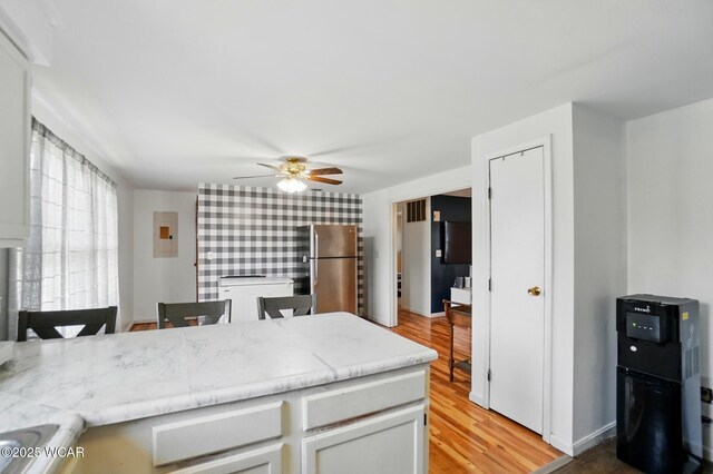 442 N Phillips Rd, Harrod, OH 45850 - kitchen featuring freestanding refrigerator, a ceiling fan, light wood-style floors, light countertops, and a peninsula