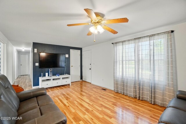 442 N Phillips Rd, Harrod, OH 45850 - living area with wood finished floors, a ceiling fan, and plenty of natural light