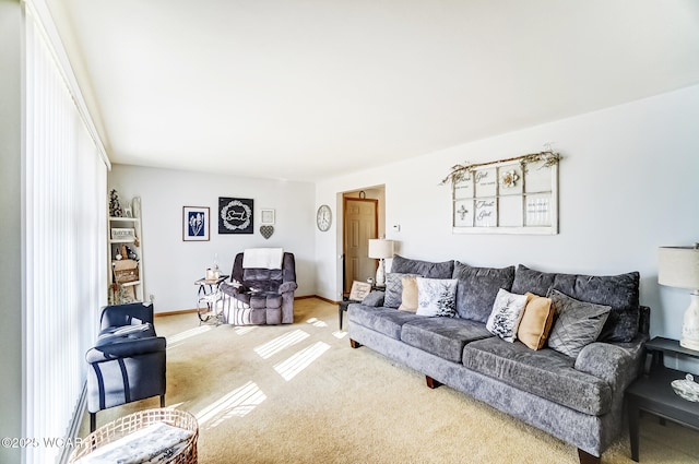 living room featuring carpet floors and baseboards