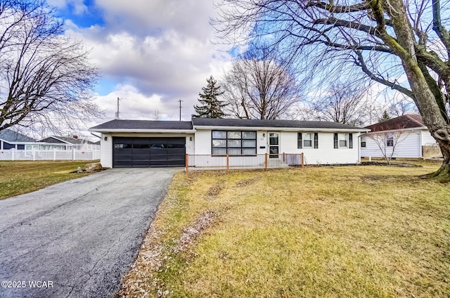 ranch-style home with aphalt driveway, a front lawn, fence, and an attached garage