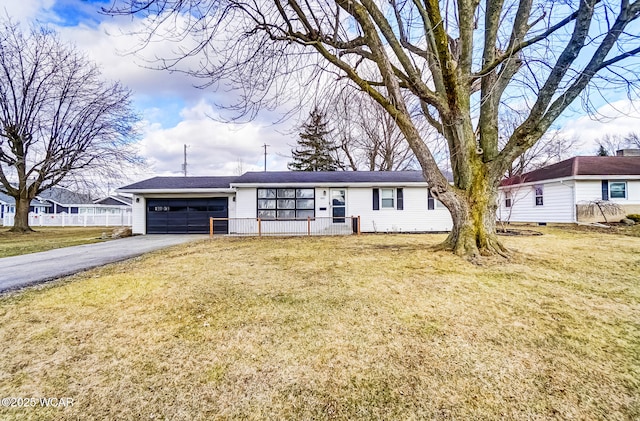 ranch-style house with a garage, aphalt driveway, a front lawn, and fence