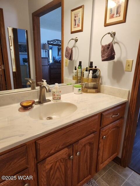 bathroom featuring tile patterned flooring and vanity