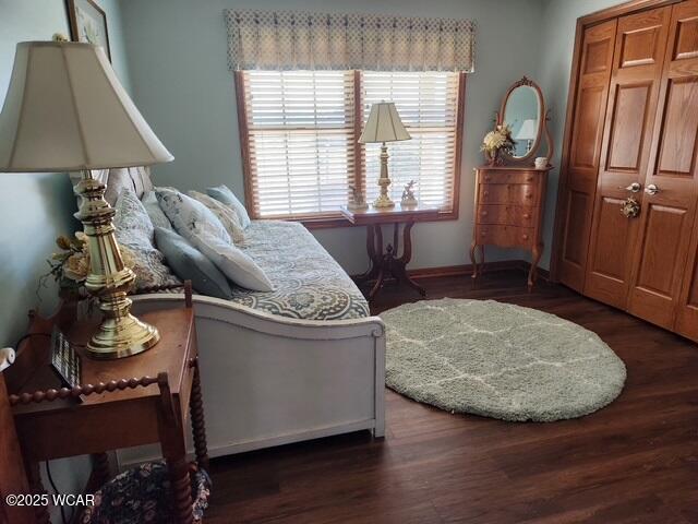 bedroom featuring baseboards and wood finished floors