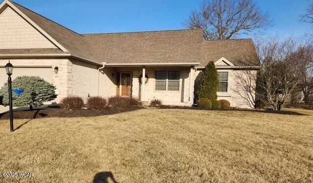 view of front of house with a front yard and a garage