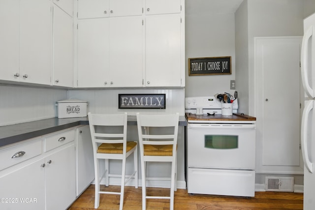 800 S Tyler St, Van Wert, OH 45891 - kitchen featuring white electric range oven, white cabinetry, and dark countertops