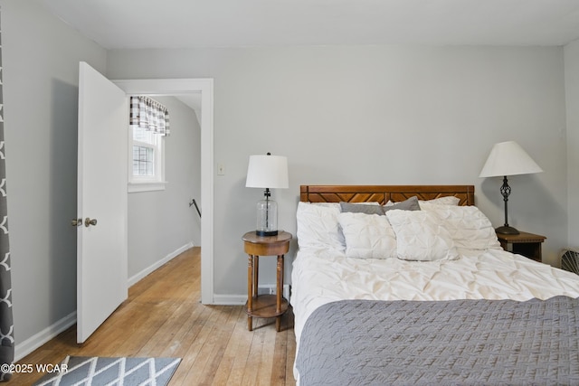 800 S Tyler St, Van Wert, OH 45891 - bedroom featuring wood-type flooring, baseboards, and a chandelier