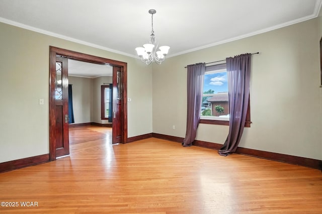 210 N Pierce St, Delphos, OH 45833 - spare room with light wood-style floors, a chandelier, and crown molding