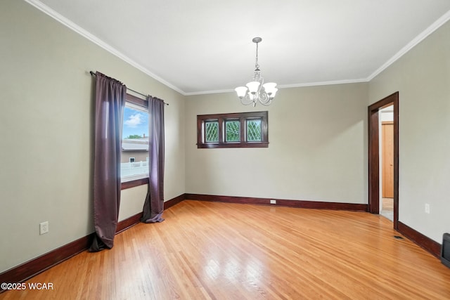 210 N Pierce St, Delphos, OH 45833 - empty room with a chandelier, light wood finished floors, and crown molding