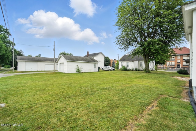210 N Pierce St, Delphos, OH 45833 - view of grassy yard with an outdoor structure and a garage