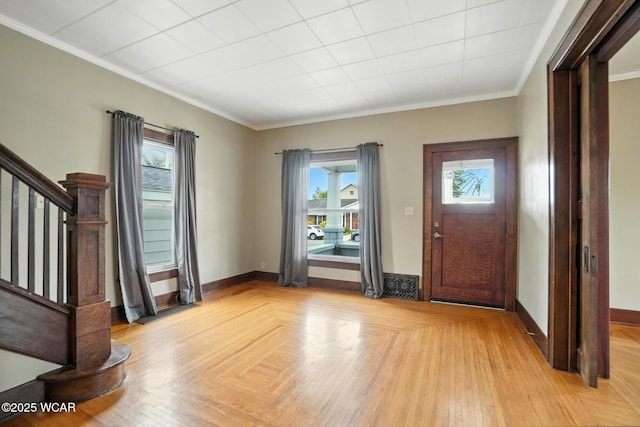 210 N Pierce St, Delphos, OH 45833 - entryway featuring healthy amount of natural light, stairs, crown molding, and light wood-type flooring