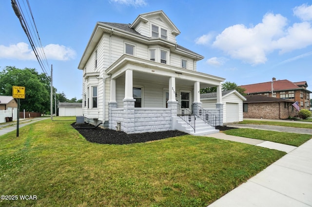 210 N Pierce St, Delphos, OH 45833 - american foursquare style home with a porch, a front yard, an outbuilding, driveway, and a garage