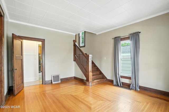 210 N Pierce St, Delphos, OH 45833 - unfurnished living room featuring crown molding and stairs