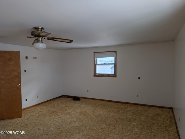 spare room featuring ceiling fan, carpet floors, and baseboards