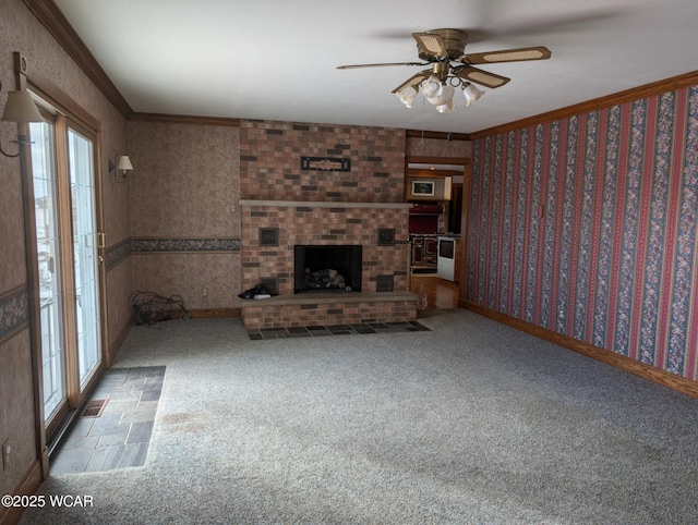 unfurnished living room with wallpapered walls, crown molding, a brick fireplace, and carpet flooring