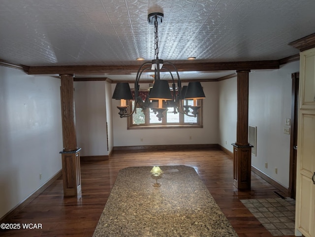 unfurnished dining area with dark wood-style flooring, decorative columns, and baseboards