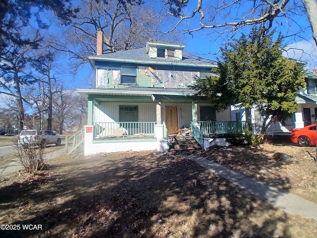 traditional style home with a porch and a chimney