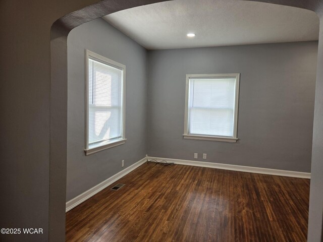 220 W N St, Elida, OH 45807 - spare room with arched walkways, dark wood-style floors, and recessed lighting
