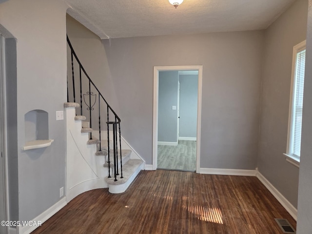 220 W N St, Elida, OH 45807 - entryway featuring wood finished floors, stairway, and a textured ceiling