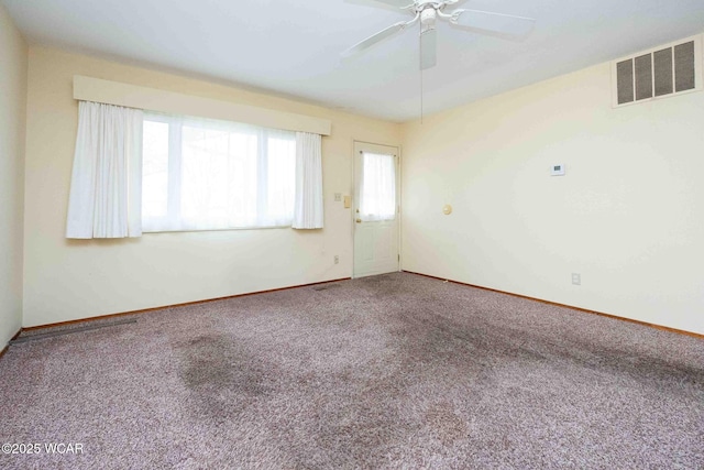 spare room featuring carpet floors and ceiling fan