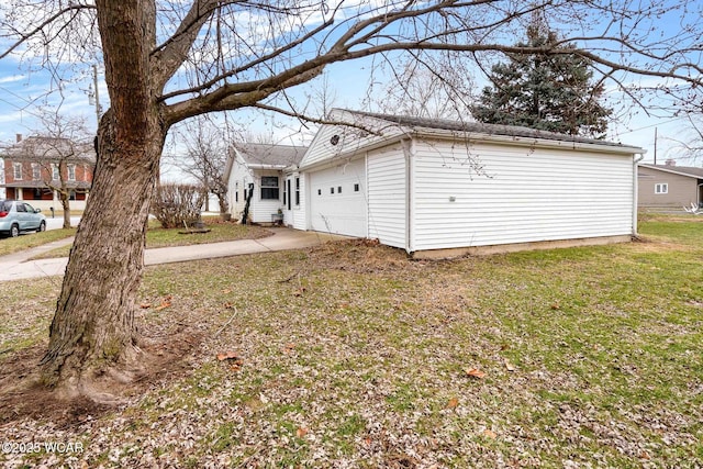 view of side of home with a garage and a yard