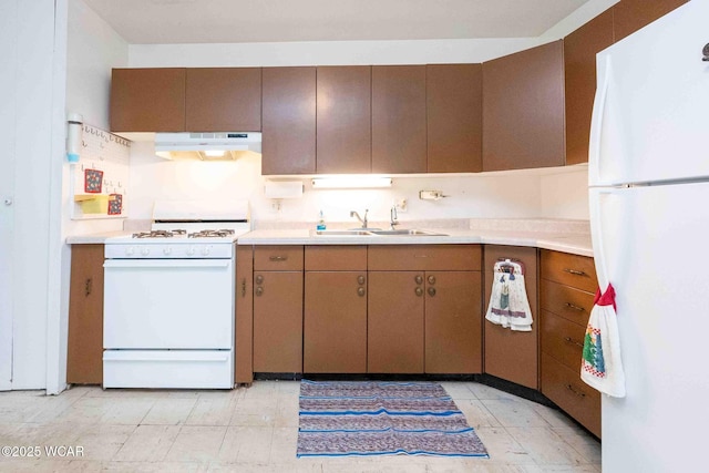 kitchen featuring white appliances and sink