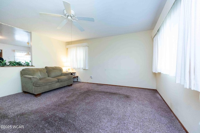 carpeted living room featuring ceiling fan