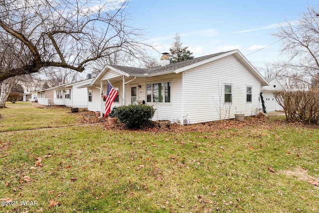 view of side of property featuring a yard and a porch