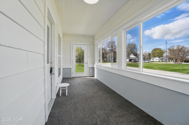 unfurnished sunroom featuring carpet