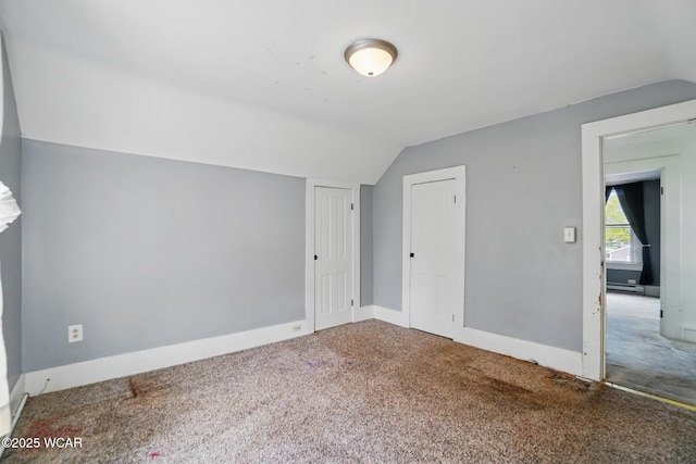 additional living space featuring lofted ceiling, carpet floors, and baseboards