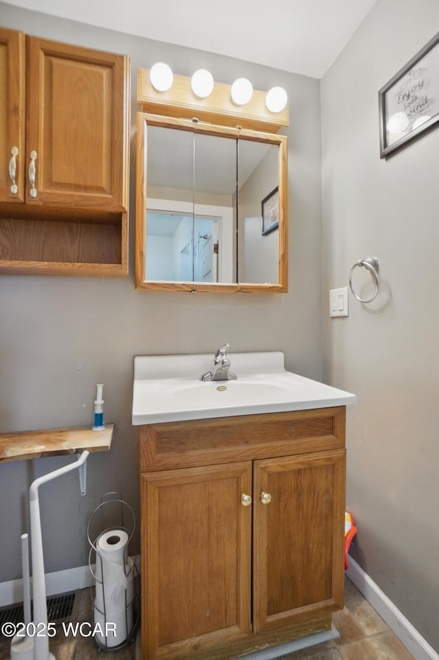 bathroom featuring vanity and baseboards