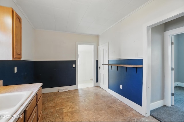 interior space with ornamental molding and vanity