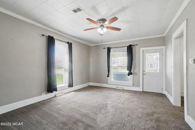 spare room featuring a wealth of natural light, crown molding, and visible vents