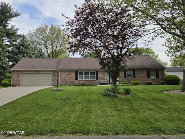 2134 Wyandot Dr, Lima, OH 45806 - single story home with brick siding, a garage, driveway, a front yard, and roof with shingles