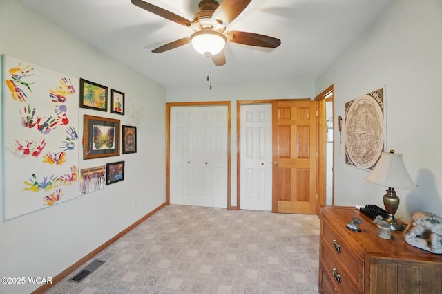 1543 Wonderlick Rd, Lima, OH 45805 - bedroom featuring multiple closets, visible vents, a ceiling fan, light carpet, and baseboards