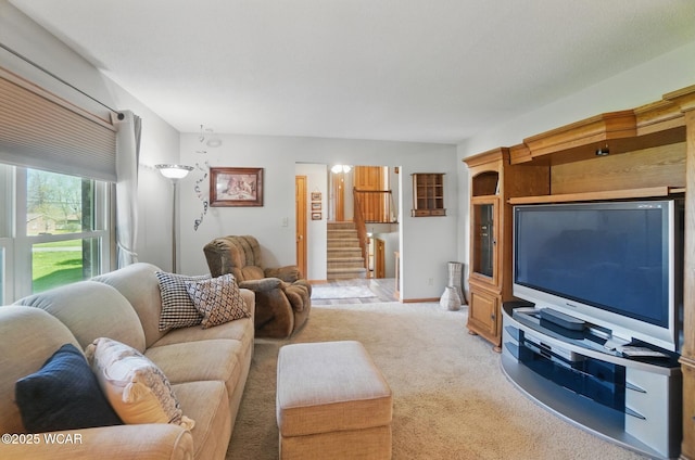 1543 Wonderlick Rd, Lima, OH 45805 - living room with stairway, baseboards, and light carpet