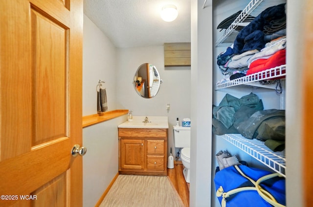 1543 Wonderlick Rd, Lima, OH 45805 - bathroom with a textured ceiling, toilet, and vanity