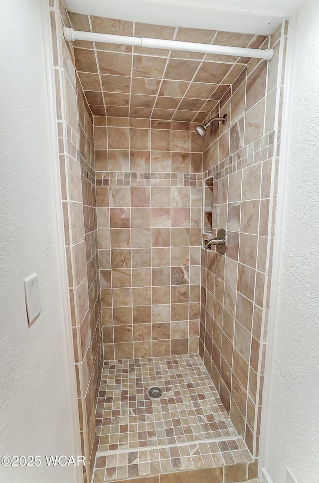 bathroom with a tile shower