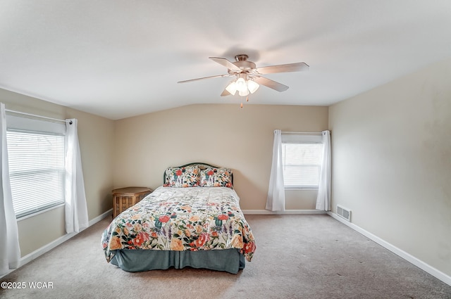 carpeted bedroom with vaulted ceiling and ceiling fan