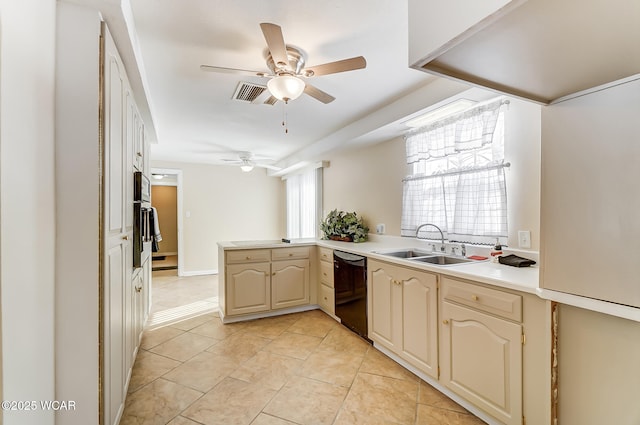 kitchen featuring a sink, a peninsula, dishwasher, ceiling fan, and a healthy amount of sunlight