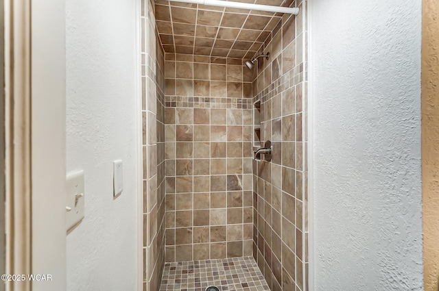 bathroom with a tile shower