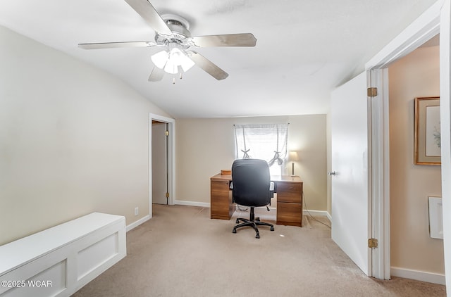 office with lofted ceiling, a ceiling fan, baseboards, and light carpet