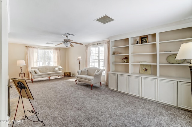 unfurnished living room featuring visible vents, light colored carpet, and a healthy amount of sunlight