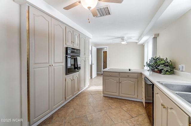 kitchen with visible vents, ceiling fan, light countertops, a peninsula, and black appliances