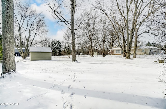 yard covered in snow featuring an outdoor structure