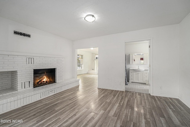 11820 County Road 17, West Unity, OH 43570 - unfurnished living room with wood finished floors and a fireplace