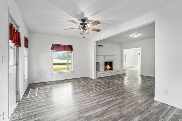 11820 County Road 17, West Unity, OH 43570 - unfurnished living room with dark wood-style floors, a ceiling fan, and a fireplace
