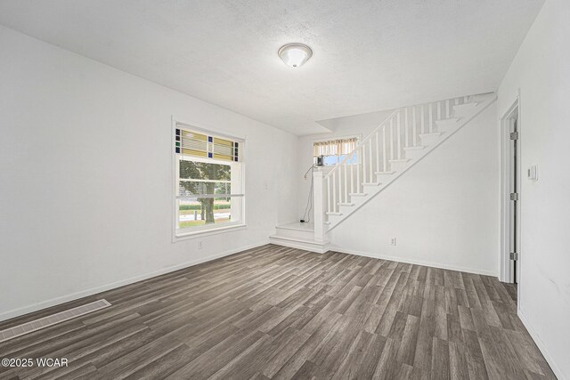 11820 County Road 17, West Unity, OH 43570 - spare room featuring stairway and dark wood-type flooring