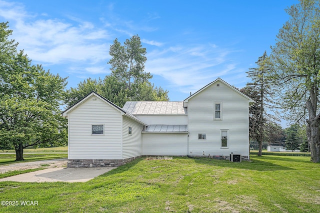 11820 County Road 17, West Unity, OH 43570 - back of property with a standing seam roof, a yard, a patio area, and a metal roof