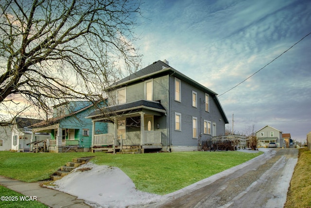 view of front facade with covered porch and a front yard