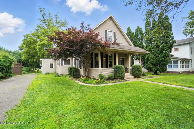 307 N Jefferson St, Van Wert, OH 45891 - view of front of home featuring covered porch and a front lawn